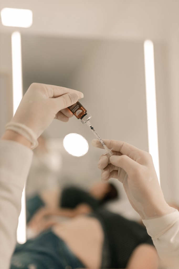 Clinician preparing a B12 injection in a treatment room